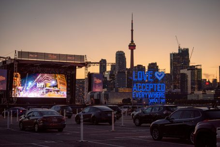 Outdoor movie screening at TIFF 2020's CityView Drive-In at dusk in Toronto with the toronto skyline in the background