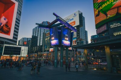 Toronto cityscape photo of the 504 streetcar on a snowy night displayed on a digital billboard at Yonge and Dundas Square