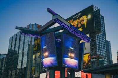 Close-up of rotating digital billboard panel displaying snowy night 504 streetcar photo by Toronto photographer Nick Wons
