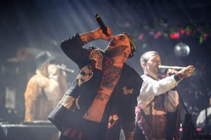 Kalush Orchestra rapping into a microphone while performing at OPera House in Toronto